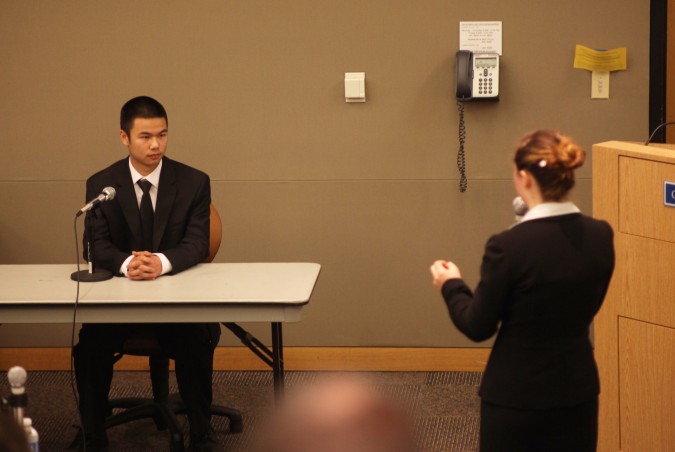 Marcus Wong, playing a police officer, is questioned by student playing attorney for the defense at San Francisco Mock Trial finals 2012, February 23, 2012