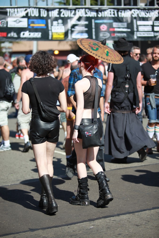 A couple walks together in the Sun at the San Francisco Folsom Street Fair, September 23, 2012. 