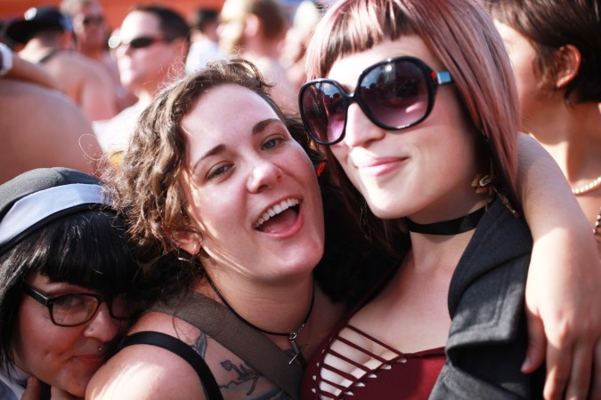 Three women pose for the camera at the San Francisco Folsom Street Fair, September 23, 2012. 