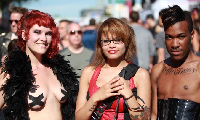 Two women and a man pose for the camera at the San Francisco Folsom Street Fair, September 23, 2012. 