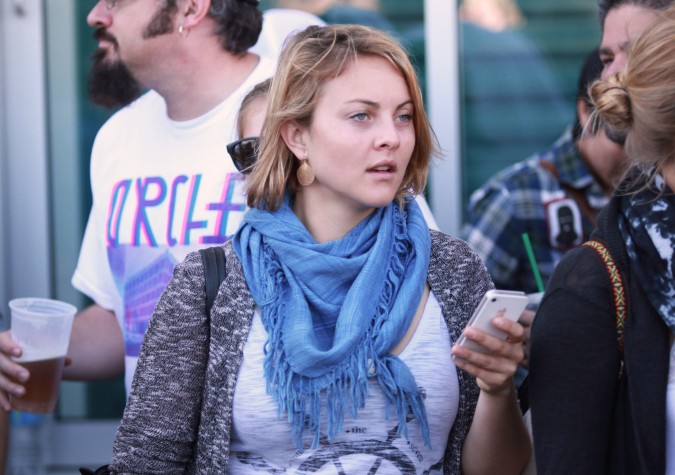 Woman uses her Apple iPhone at the San Francisco Folsom Street Fair, September 23, 2012. 