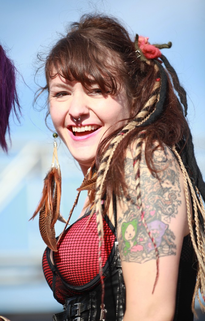 Woman with amazing ear rings poses for the camera at the San Francisco Folsom Street Fair, September 23, 2012. 
