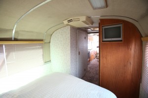 1967 MCI 5A Challenger Bus Conversion, bedroom looking toward bathroom and TV